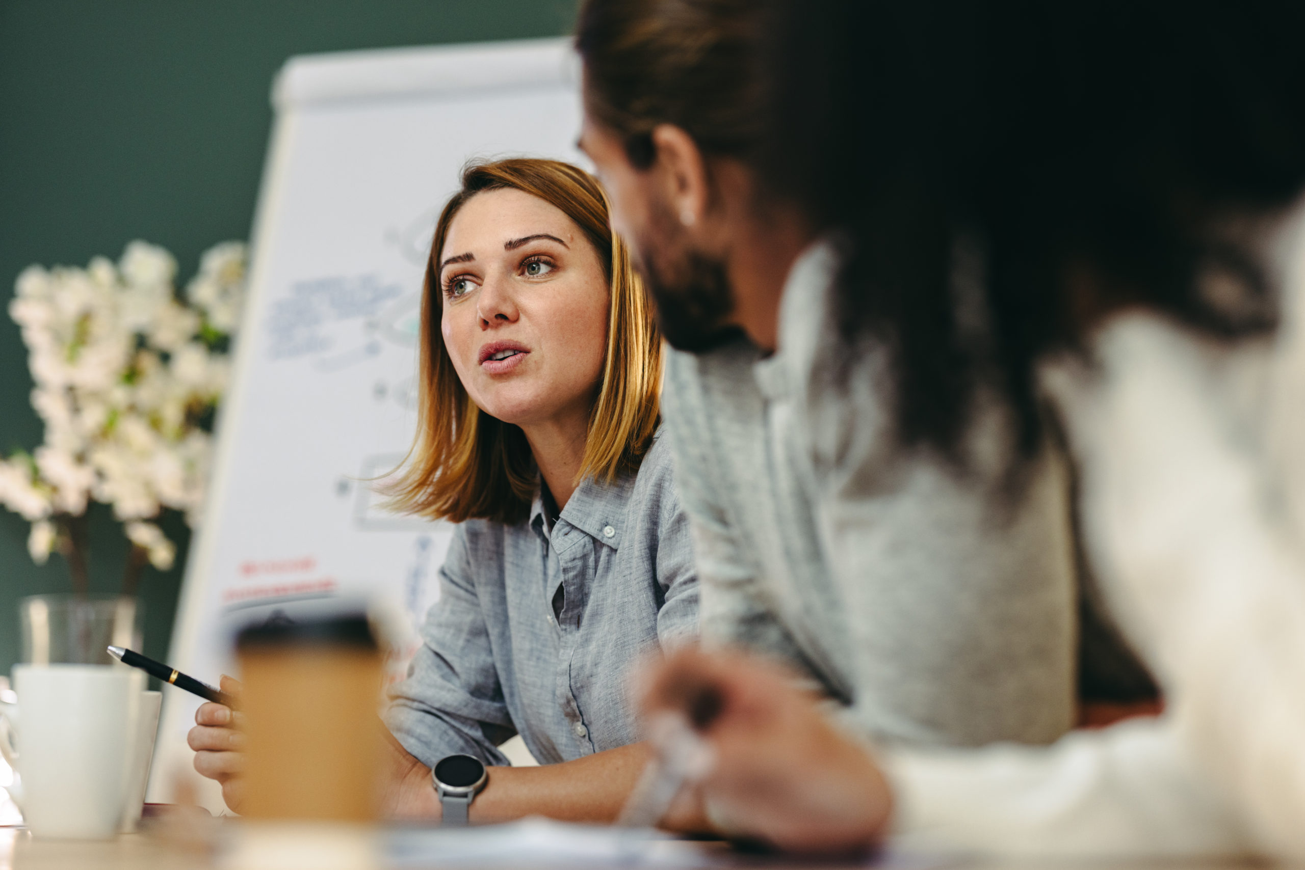 Young Businesswoman Having A Discussion With Her Colleagues In A Meeting